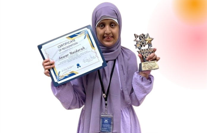   student Anwar Haidarah holding an award  